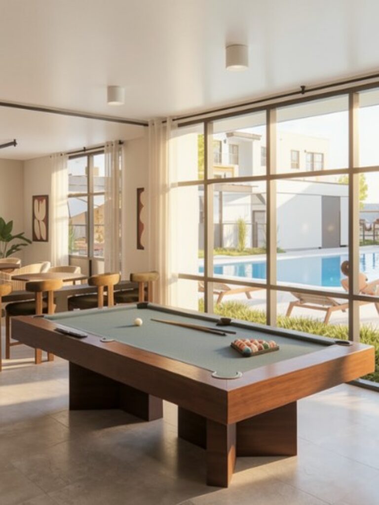 Amenity lounge with pool table, seating area, and large windows overlooking the pool at The Bob Apartments