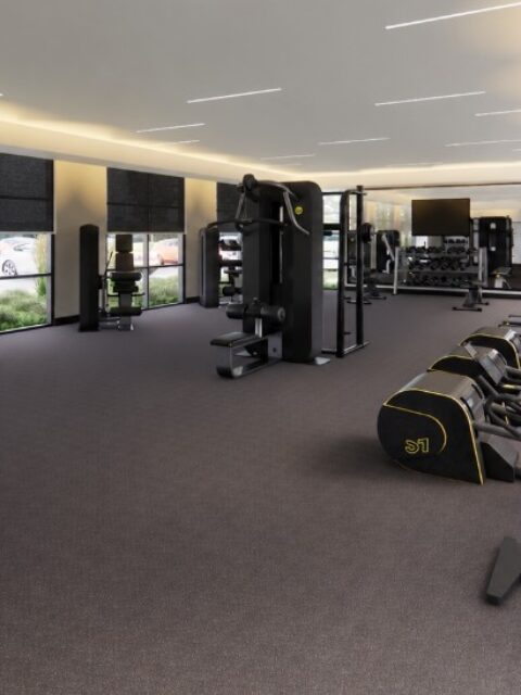 Modern apartment gym with cardio machines, strength equipment, and large windows at the Bob Apartments in Richland, WA