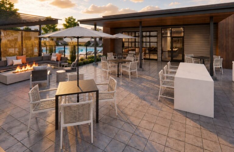 Rooftop lounge at The Bob Apartments with fire pit seating, dining tables, umbrellas, and grills at sunset