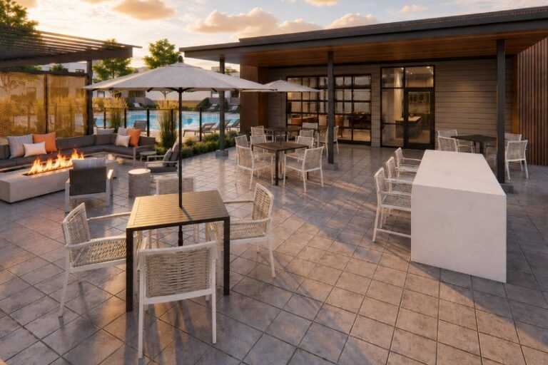 Rooftop lounge at The Bob Apartments with fire pit seating, dining tables, umbrellas, and grills at sunset